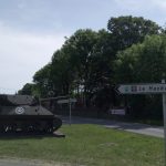 Disused American tank and the road to hill Hackenberg